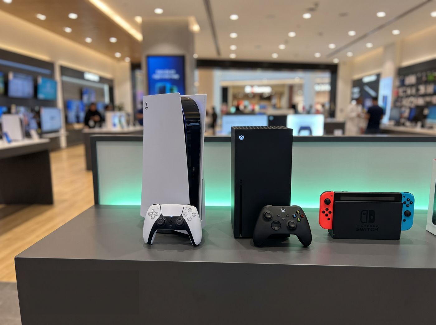 PlayStation 5, Xbox Series X and Nintendo Switch on a display counter